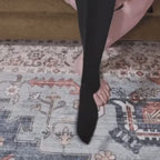 Putting on Calmyo zip-up compression socks using the full-length zip